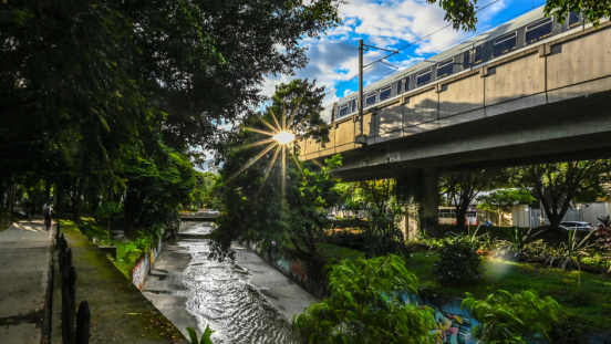 Sunlight reflected on a window pane of a train passing by in a city